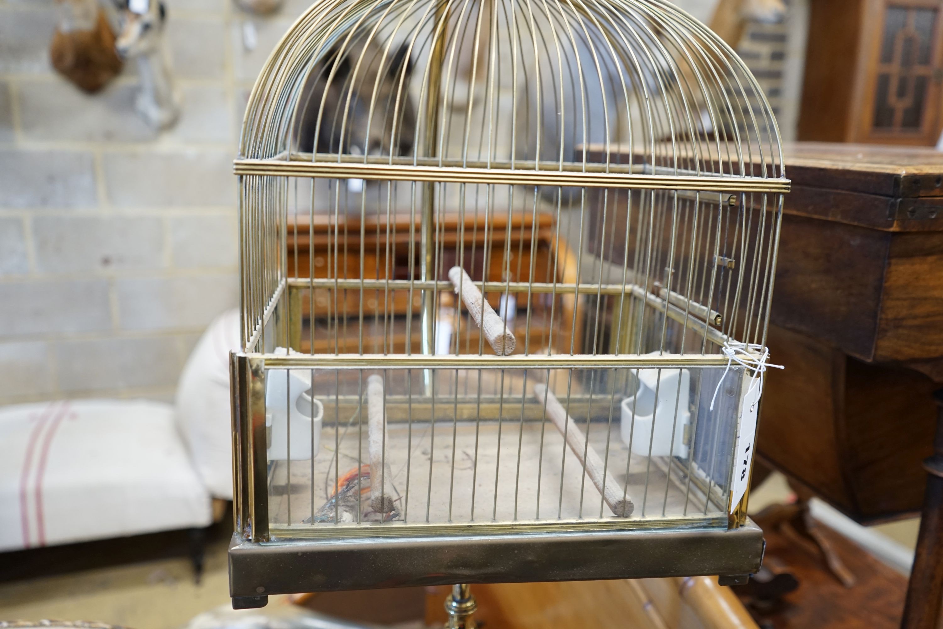 A brass ‘GenyKage’ canary cage on telescopic brass stand, width 31cm depth 23cm height 162cm